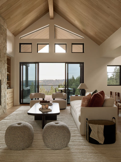 Designed by Ethan Charles Design, a living room with vaulted ceilings and a lake view in the Black Rock community of Coeur d'Alene, Idaho.