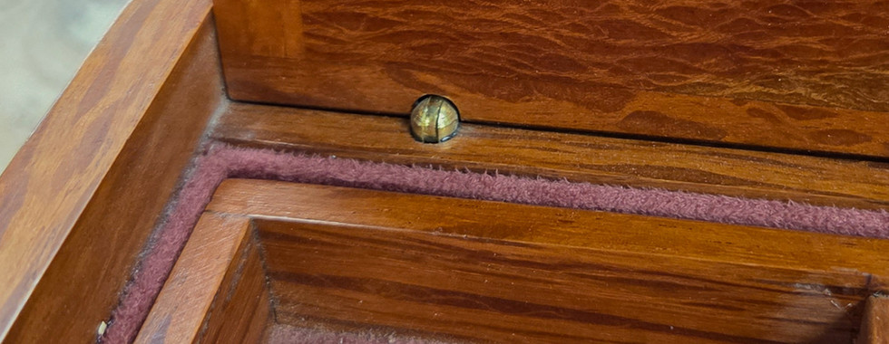 Photo of section of a box that uses a brass barrel hinge