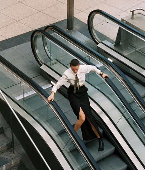 women wearing BETTTER on escalator