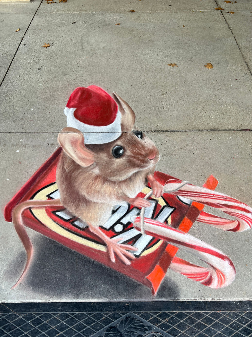 3D chalk art of a mouse wearing a Santa hat, riding a sleigh made out of KitKats and candy canes