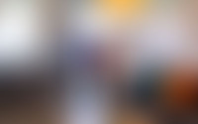 Four people walking through the front door of a home.