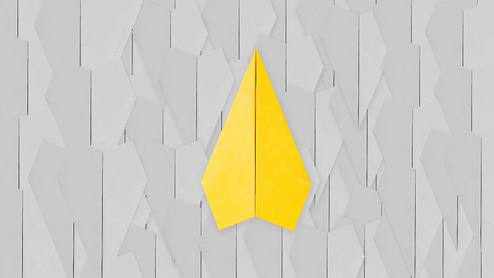 A bright yellow paper airplane stands out against a background of many grey ones, symbolizing how clear thinking and a focused main message help work reports stand out to managers instead of gathering digital dust.
