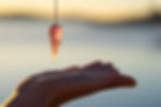 pendulum-over-a-hand-seen-up-close-in-nature-2025-01-08-03-41-35-utc.jpg