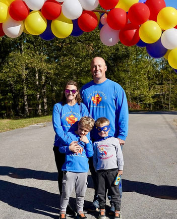 Sawyer's family the Burch's posing under the balloon arch on race day