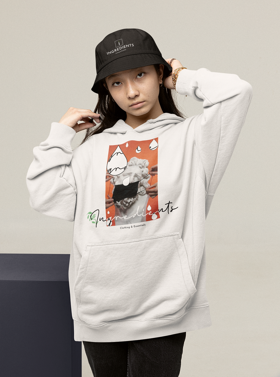 hoodie-mockup-of-a-teenager-wearing-a-bucket-hat-and-touching-her-hair-26668 2.png