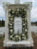 Extravagant white floral wedding ceremony arch and custom-framed welcome signage by Stellar Events in South Georgia.