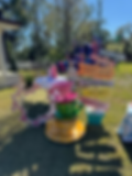 Fun and extravagant Alice in Wonderland themed party decor featuring oversized teacups and custom signage by Stellar Events.