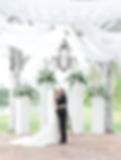 A bride and a groom at a wedding under the altar.