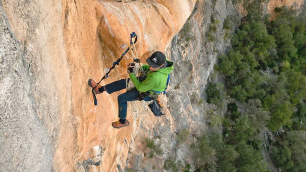 Cameraman hanging on a rock
