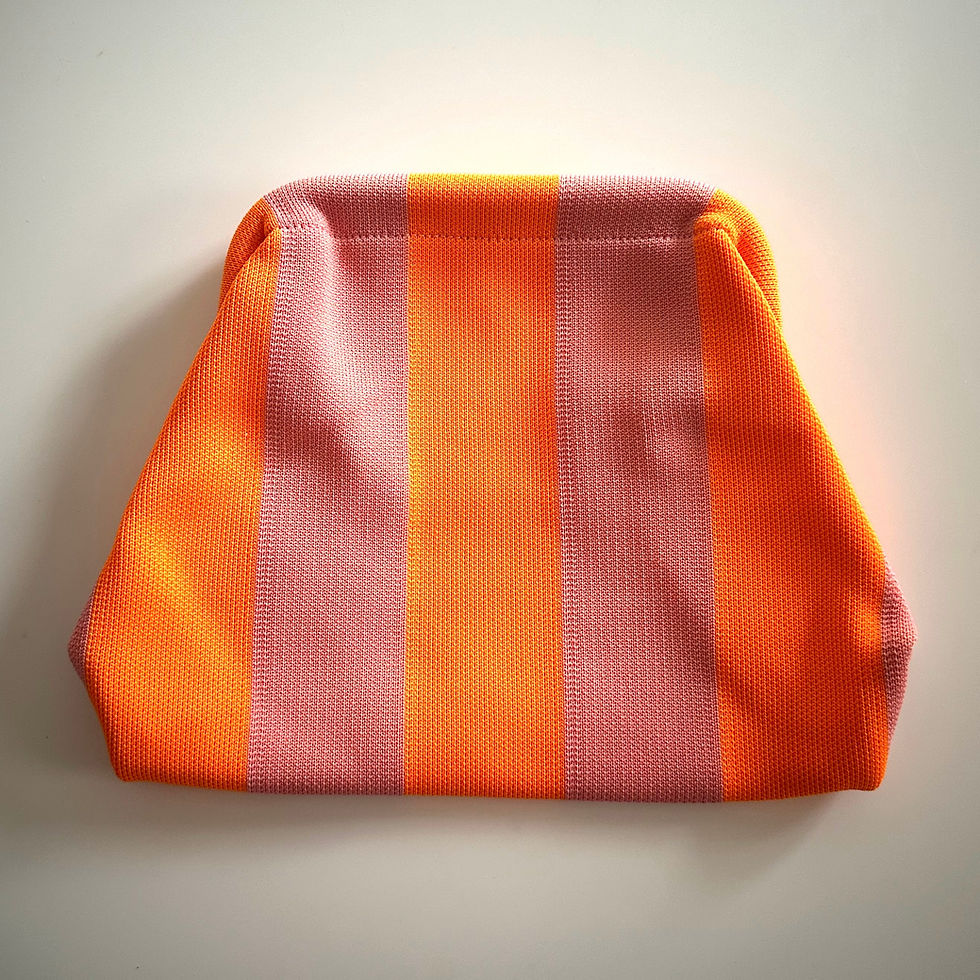 Knitted stripe clutch bag in pink and orange