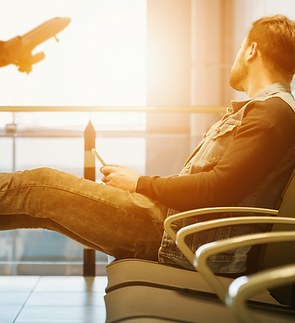 man sitting on gang chair with feet on l
