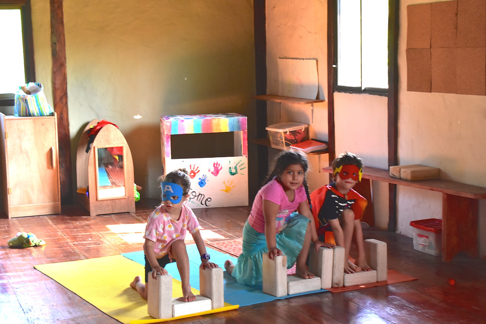 The children practicing super hero yoga.