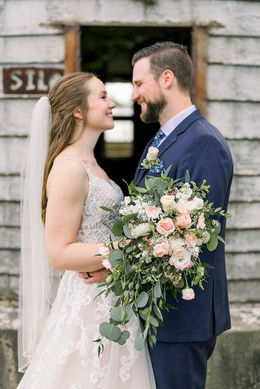 Happy couple bride holding wedding flowers