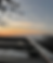 Mountain Movers aluminum roof rack at sunset overlooking a mountain landscape.