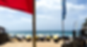 Dreamland Beach Bali viewed through beach flags in Uluwatu