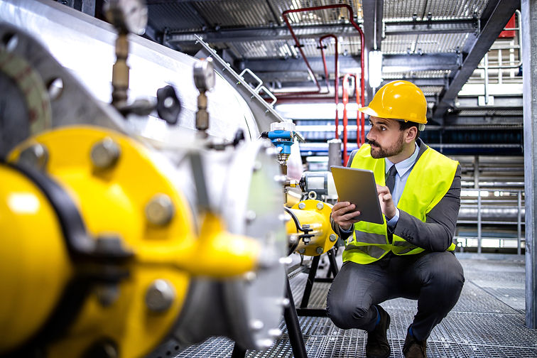 Oil and gas production manager or supervisor with digital tablet checking natural gas supp