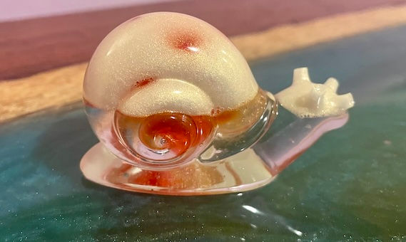 Clear, white and red decorative snail