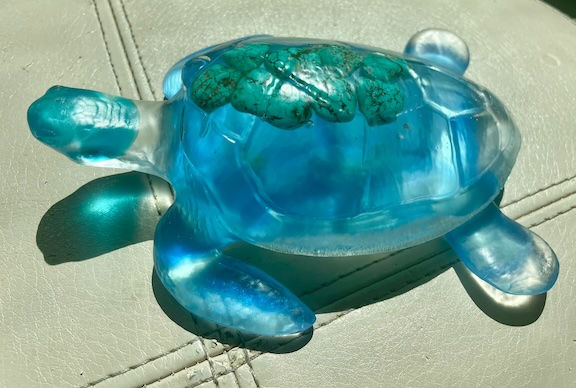Thumbnail: Translucent blue turtle with turquoise polished rocks