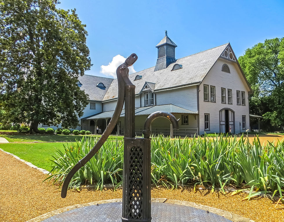 Front angle of the Belle Meade Plantation. Featured is a historic well and the plantation's main house.