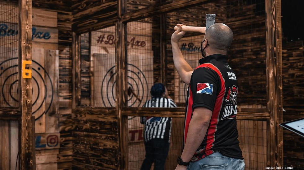 A man throwing a hatchet at a wooden target