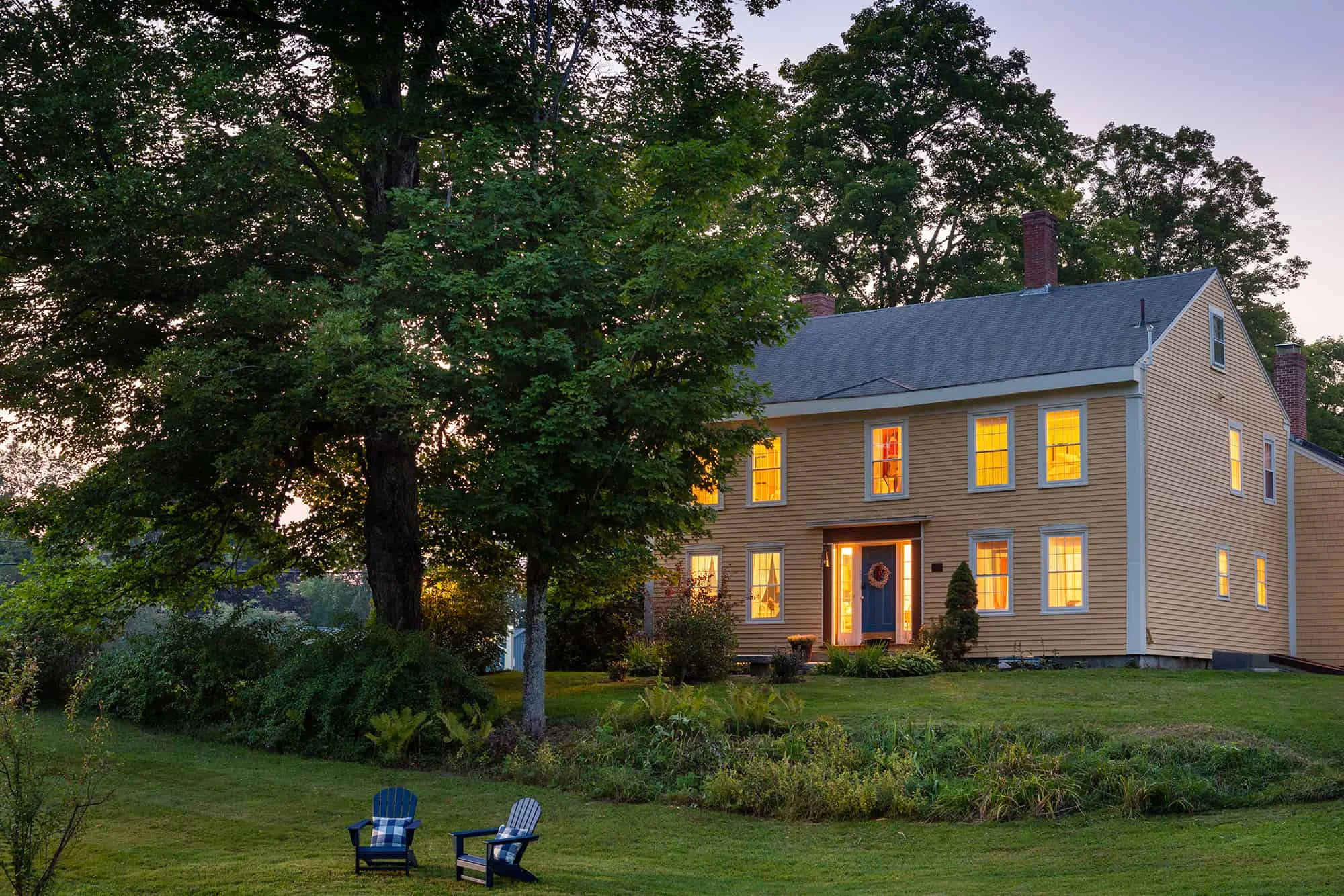outdoor view with grass hill and quaint B&B