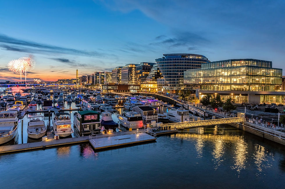 modern architecture style buildings set next to a riverside wharf at night