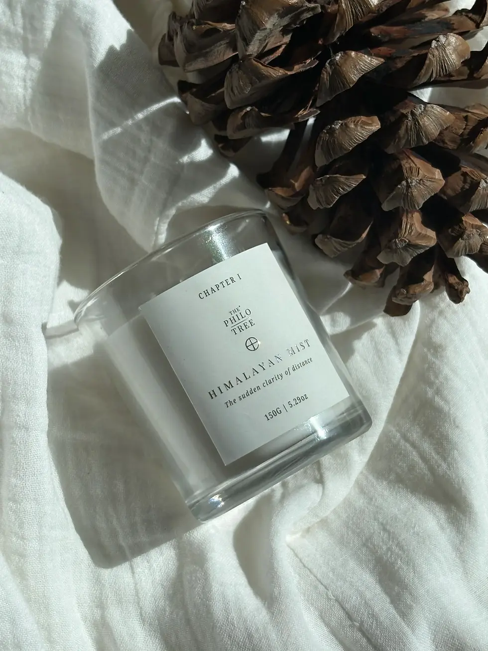 Scented candle burning in a bedroom — The Philotree Linen Grove