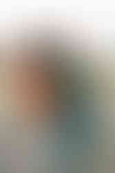 A boy and a girl running towards a camera in front of mom and dad