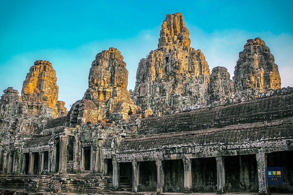 Ancient stone temple with multiple towers against a clear blue sky. Weathered details and soft golden light create a serene atmosphere.