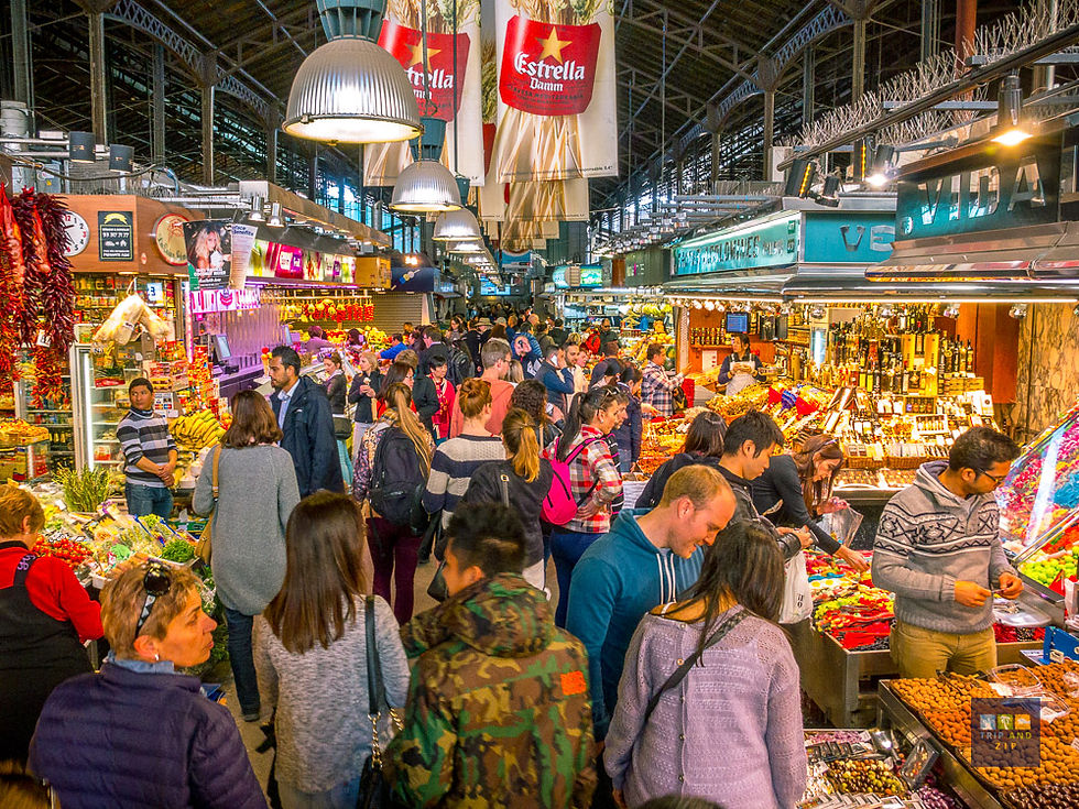Busy market scene with people shopping at colorful stalls filled with fruits, vegetables, and spices. Overhead signs read Estrella.