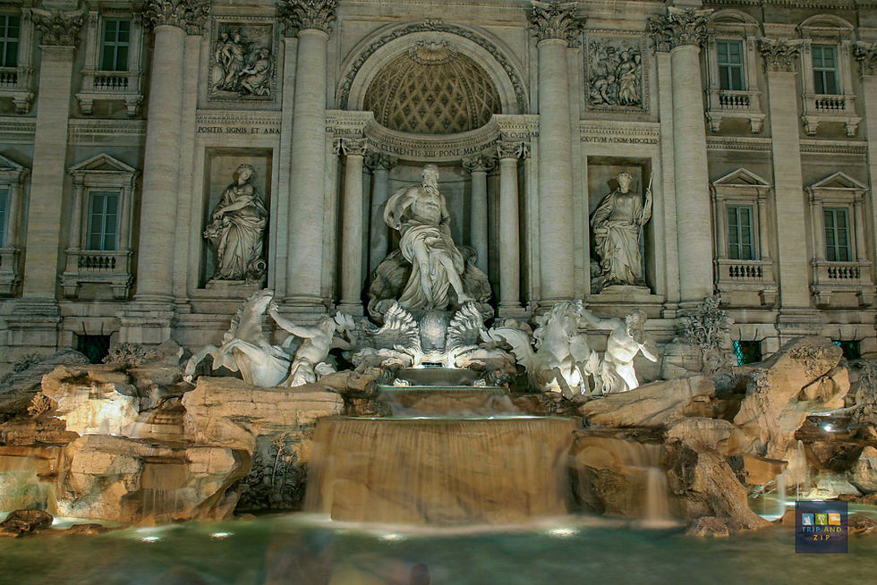 Illuminated Trevi Fountain at night, Rome. Statues with flowing water in front of a grand building, creating a serene, majestic atmosphere.