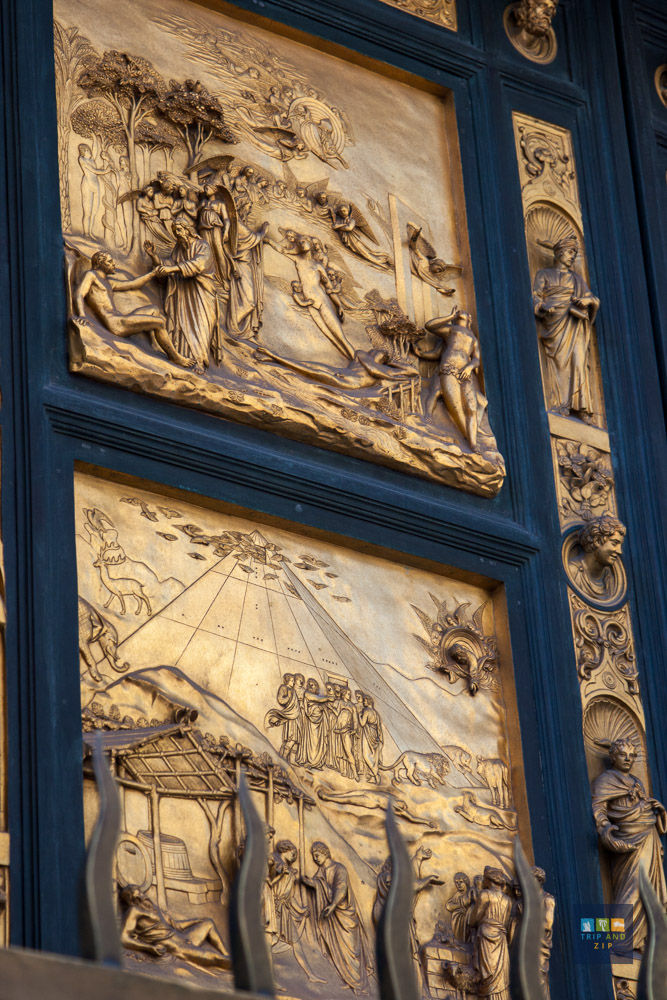 Golden panel with intricate scenes of biblical figures and events, surrounded by a dark blue frame. Detailed and ornate relief art.