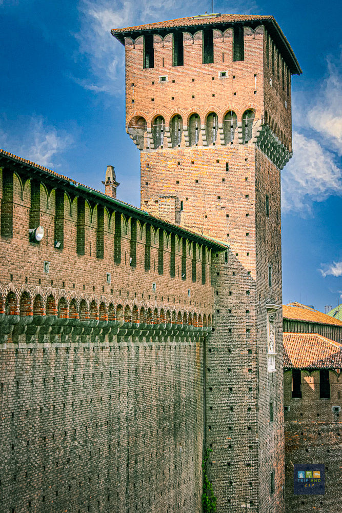Brick castle tower under a blue sky, with arched windows and clock. Sunlit wall with shadow details. Text: "TREND ZAF" at bottom right.