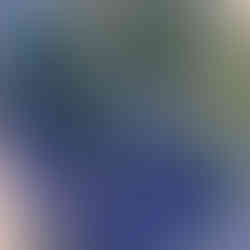 Close-up of a vase with blue, green, and white crystalline glaze patterns.