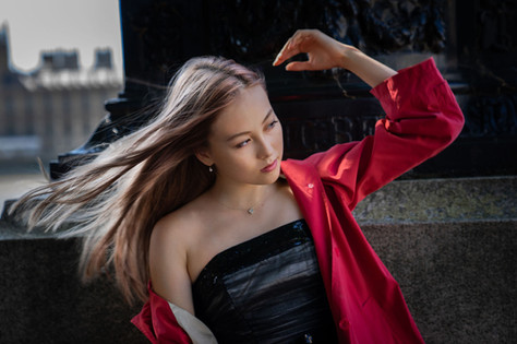 beautiful Portrait photography of a ballerina with long hair and a red coat
