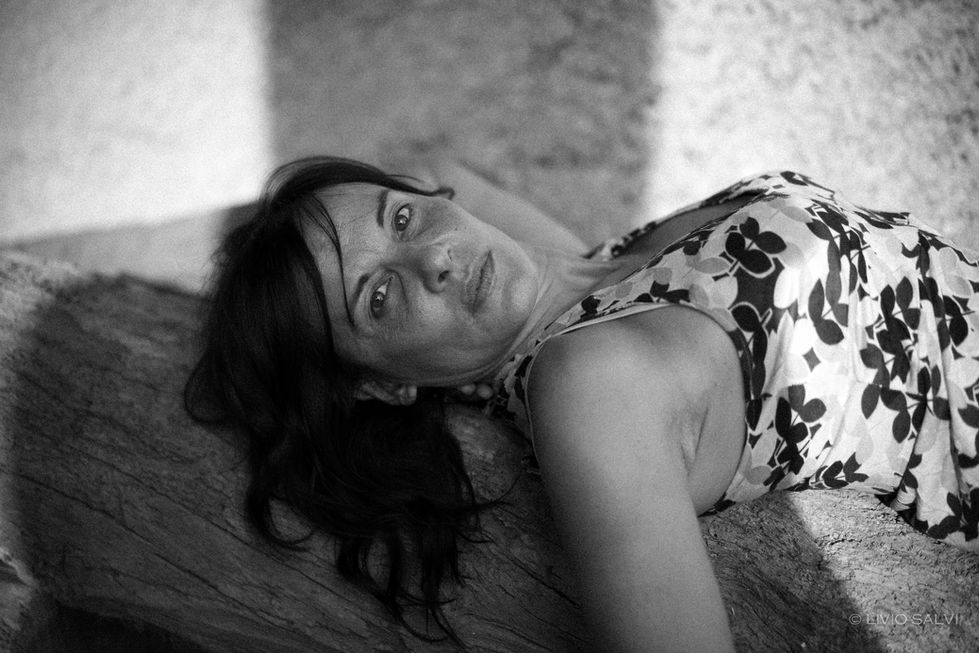 beautiful Portrait photography of a Italian woman lying on a tree
