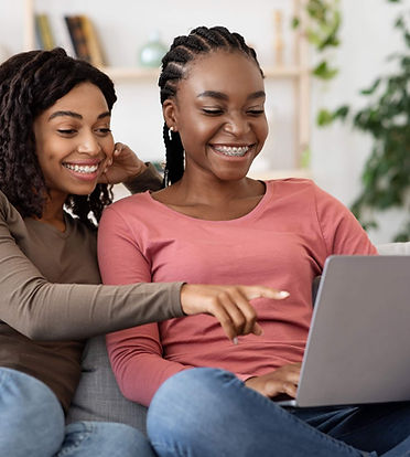 happy-black-women-using-laptop-at-home-websurfing-2021-08-29-23-01-26-utc (1).jpg