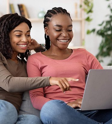 happy-black-women-using-laptop-at-home-websurfing-2021-08-29-23-01-26-utc (1).jpg
