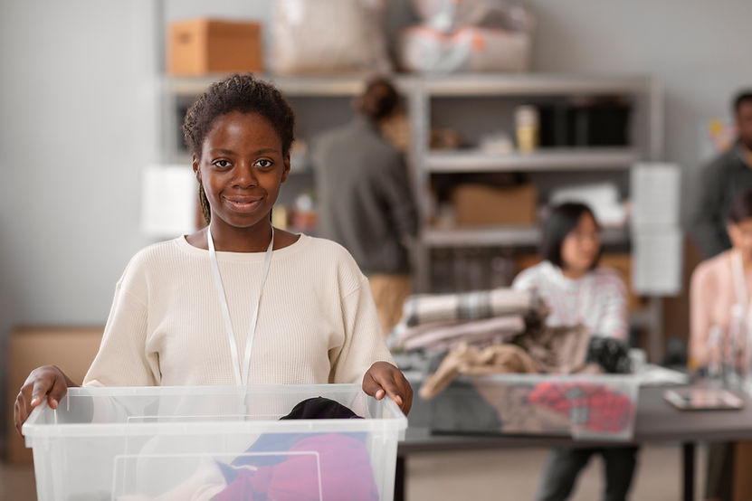 volunteer-selecting-organizing-clothes-donations-charity.jpg