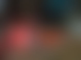 On a glass coffee table next to a tea light lies a copy of Paula Hawkins' psychological thriller A Slow Fire Burning. On it, is perched a pair of glasses. Photo by Ninay Desai.