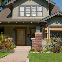 a house with cleaned gutters and a pressure washed driveway