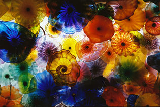 Glass pieces created by artist Chihuly line a hotel ceiling in Las Vegas