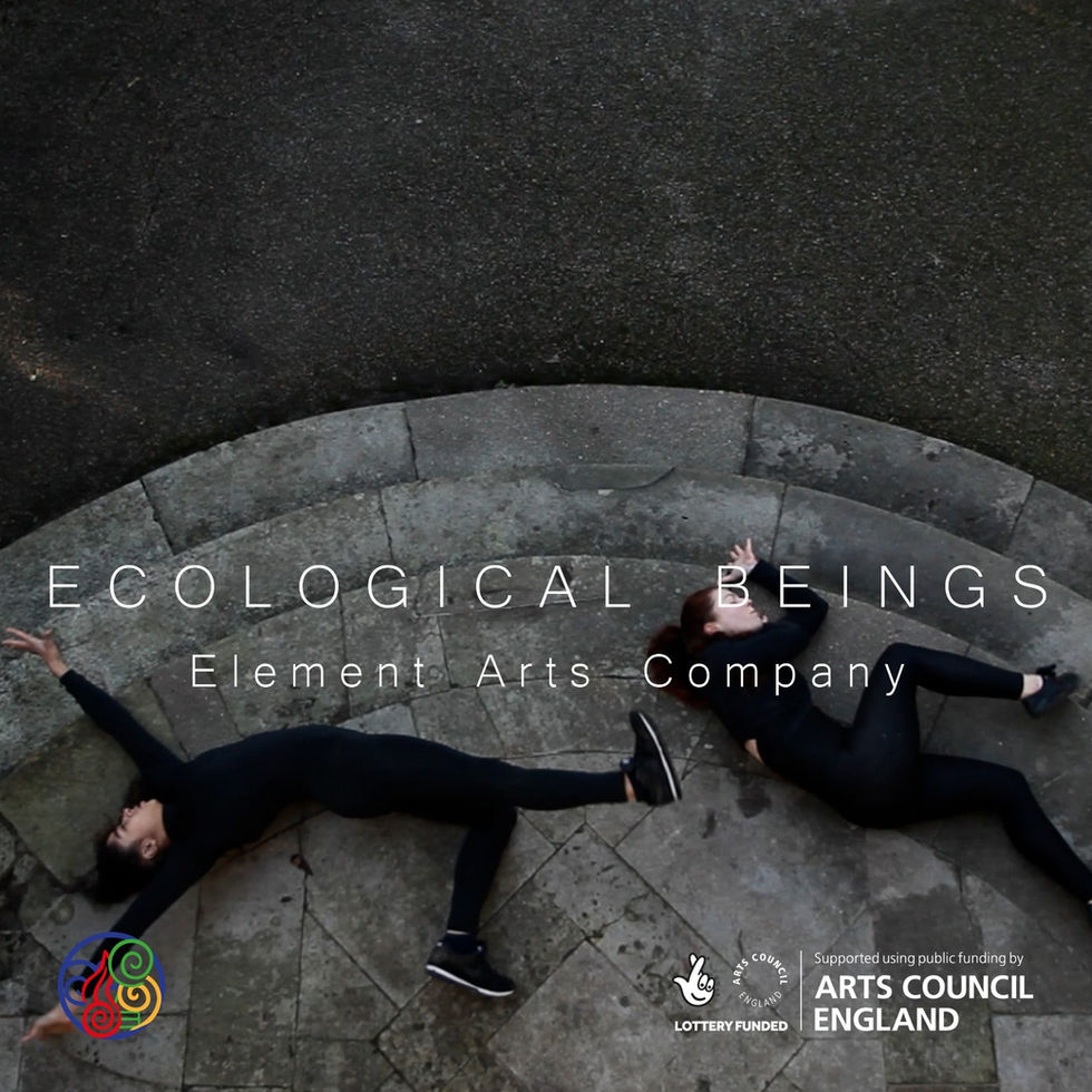 Two dancers in black catsuits lie outside on the floor making curves with their bodies, shot from a bird's eye view