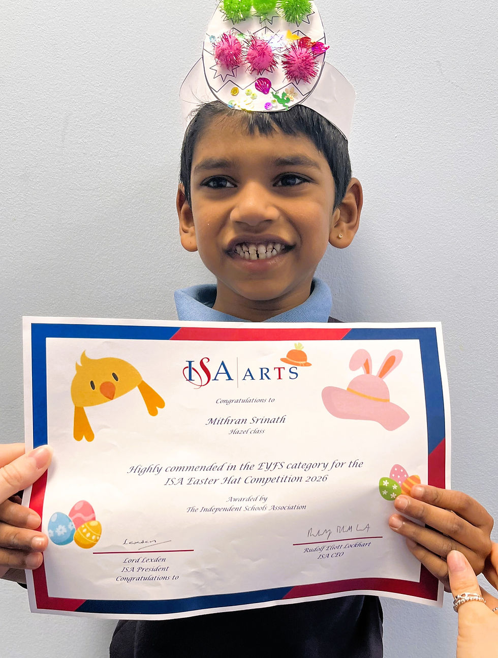 Mithran from Hazel class wearing his Highly Commended Easter hat and holding his certificate