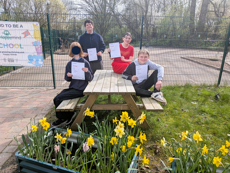 Four students from Ash class proudly holding their ASDAN Personal Development Programme Bronze certificates