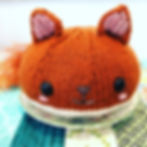 A squirrel bun-shaped toy, sitting on a plate