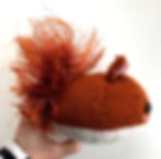 Side view of the squirrel toy, showing the bushy tail