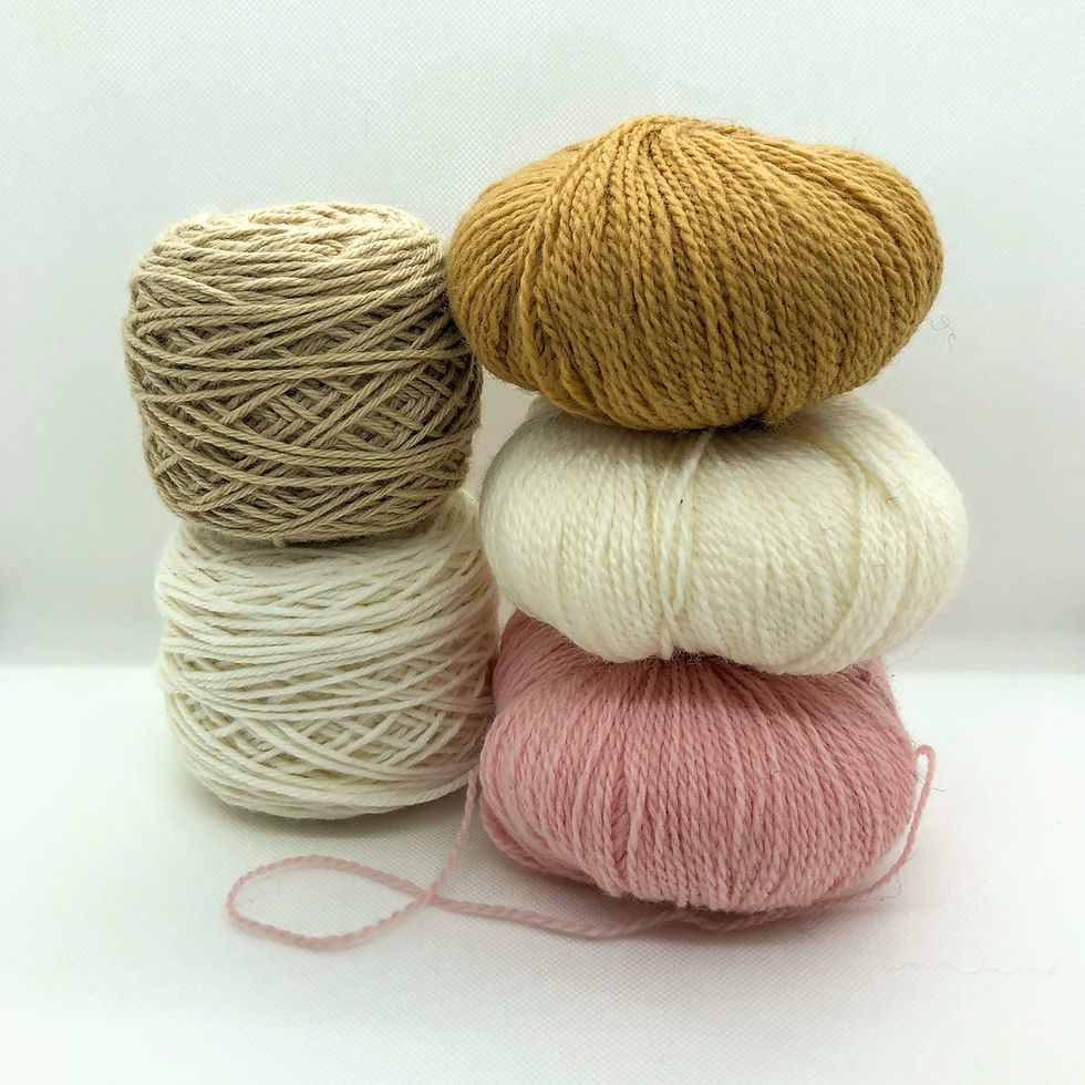 two stacks of yarn balls, in colours of light brown, white, and pink