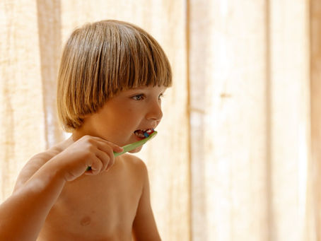 A kid is brushing teeth