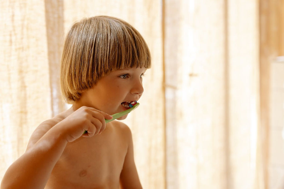 A kid is brushing teeth